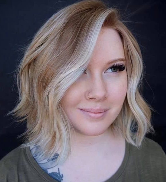 A woman with blonde hair and green shirt.