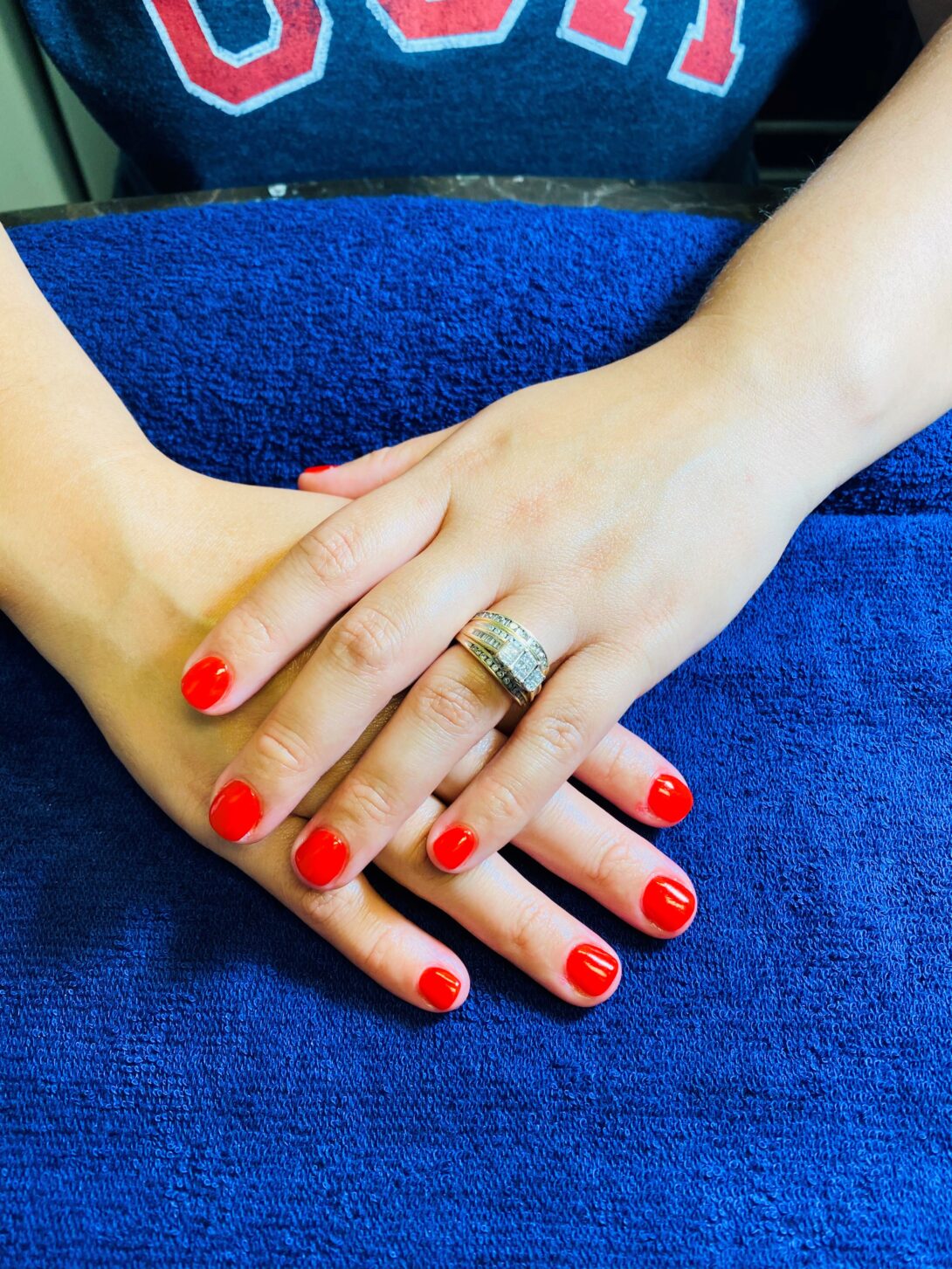 A woman with red nails is holding her hand