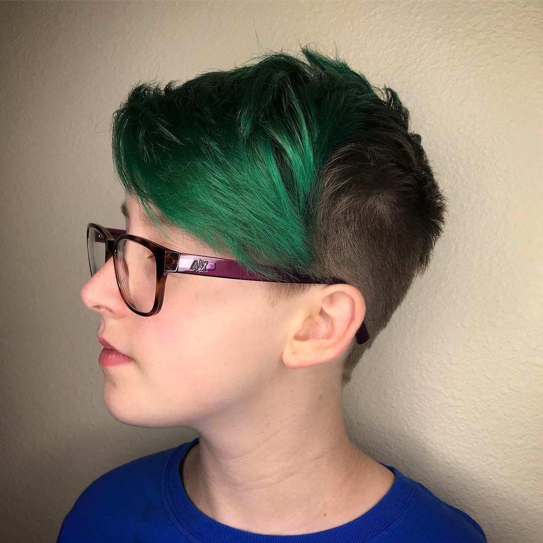 A boy with green hair and glasses