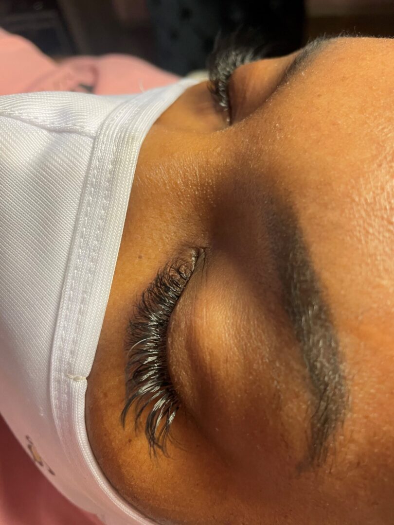 A close up of a person 's eye with long eyelashes